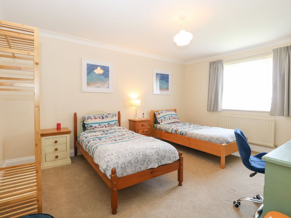A bedroom with two beds and a window at The Bungalow in Walcott