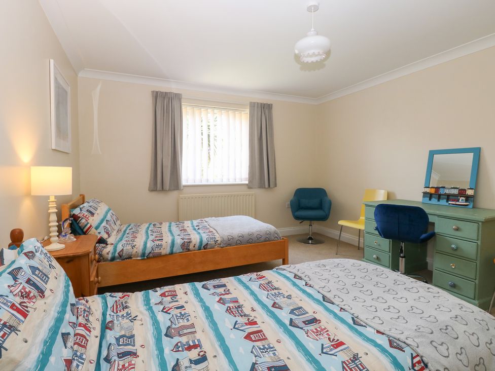A bedroom with two beds and seating area at The Bungalow in Walcott