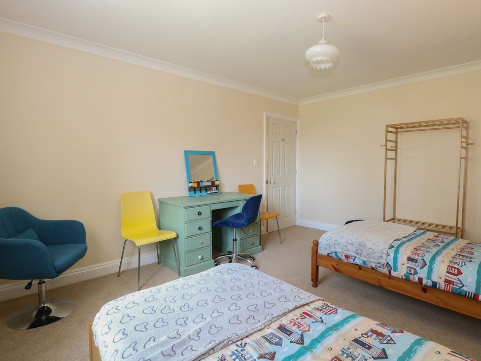 A bedroom with beds and a desk at The Bungalow in Walcott