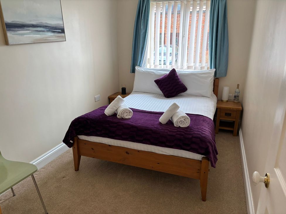 A bedroom with a bed and wall art at The Bungalow in Walcott
