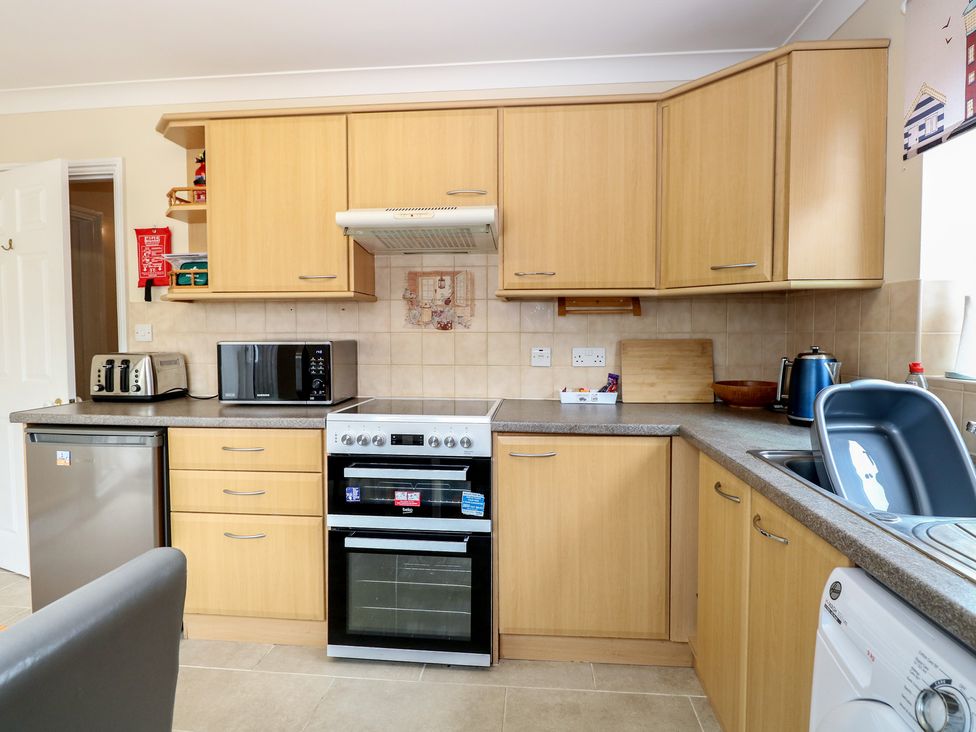 A kitchen with appliances including an oven and refrigerator at The Bungalow in Walcott