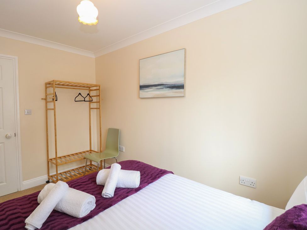 A bedroom with a bed and towels displayed at The Bungalow in Walcott