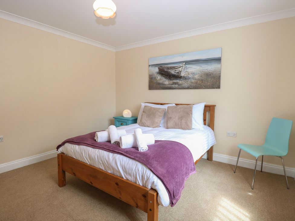 A bedroom with a bed and painting at The Bungalow in Walcott