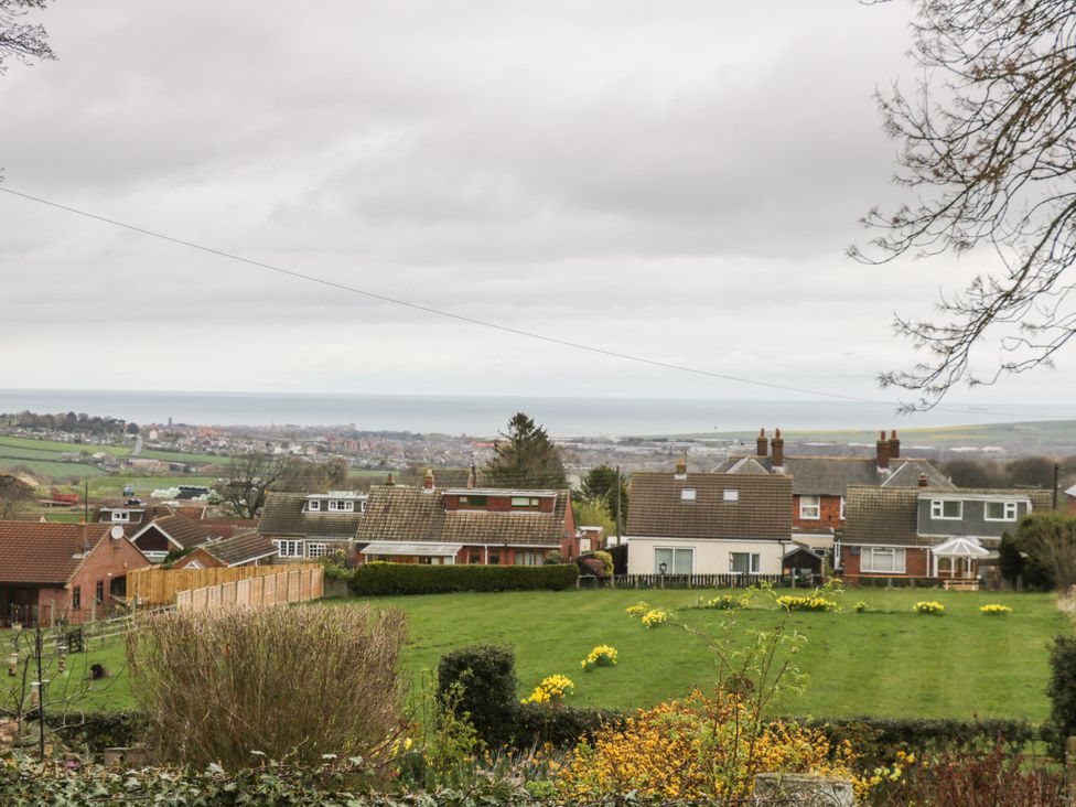 A view of houses and garden with the sea in the background at The Calf House Lingdale near Saltburn-by-the-Sea