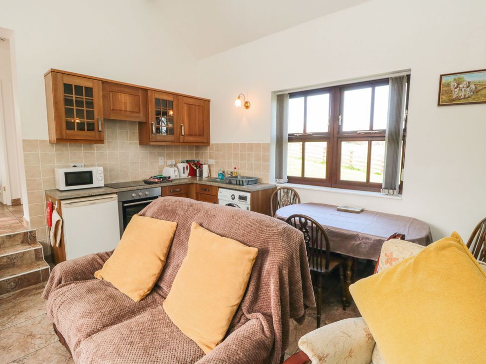 A kitchen with dining area and appliances at The Calf House in Lingdale near Saltburn-by-the-Sea