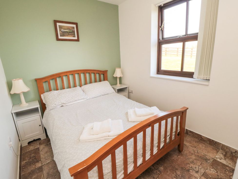 A bedroom with a bed and bedside tables at The Calf House in Lingdale near Saltburn-by-the-Sea