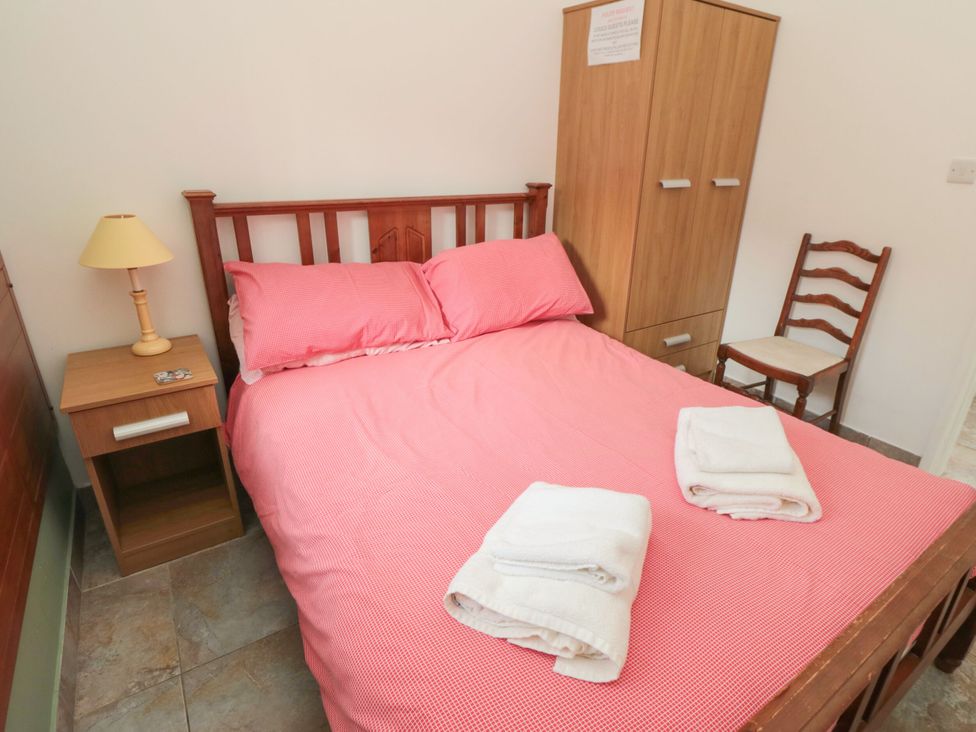 A bedroom with a bed and nightstand at The Cow Byre in Lingdale