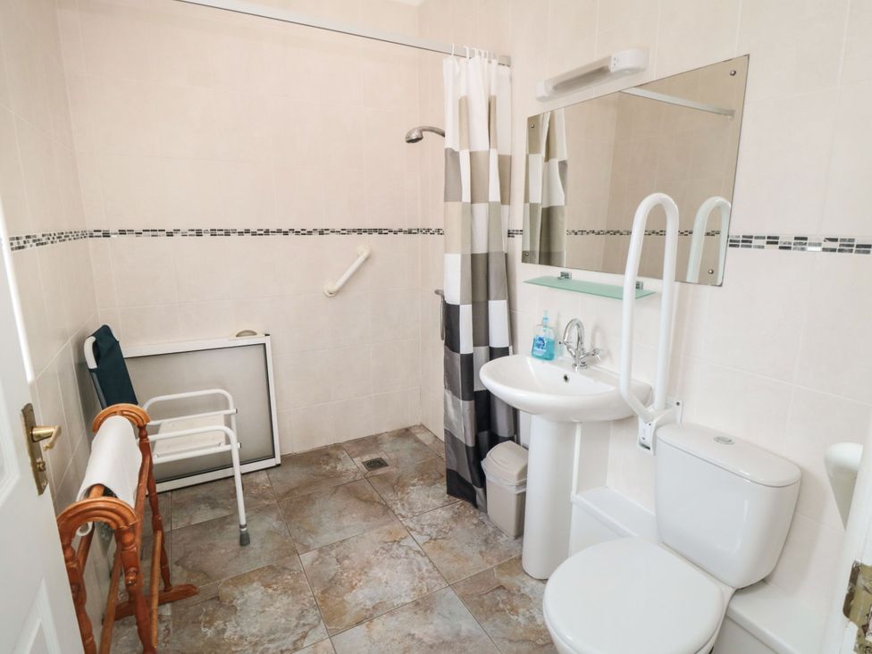A bathroom with a shower, toilet, and sink at The Cow Byre in Lingdale