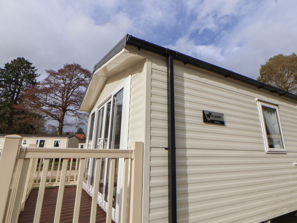 A caravan with a deck and windows at Willerby Malton in Ruthin