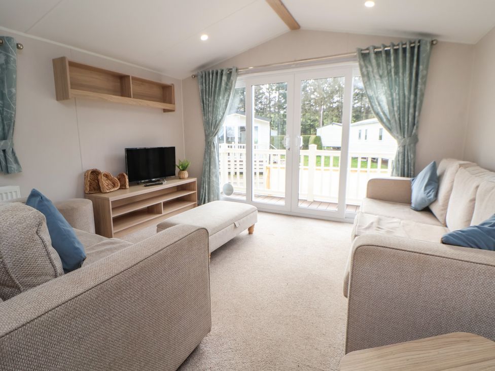 A living room with a TV and sofa at Willerby Malton 176 in Ruthin