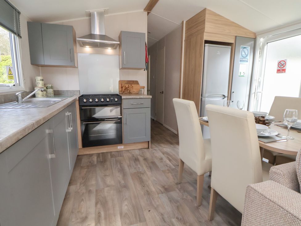 A kitchen with a sink and oven at Willerby Malton 176 in Ruthin