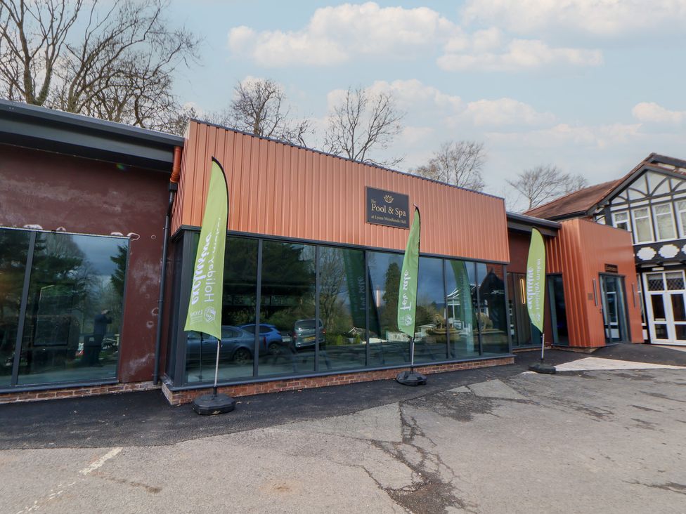 A building with glass windows and flags outside at Willerby Malton 176 Ruthin
