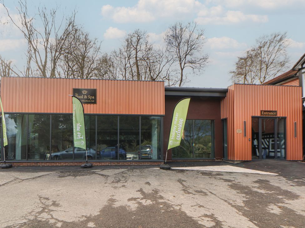 A pool and spa building with entrance and flags at Willerby Malton 176 Ruthin