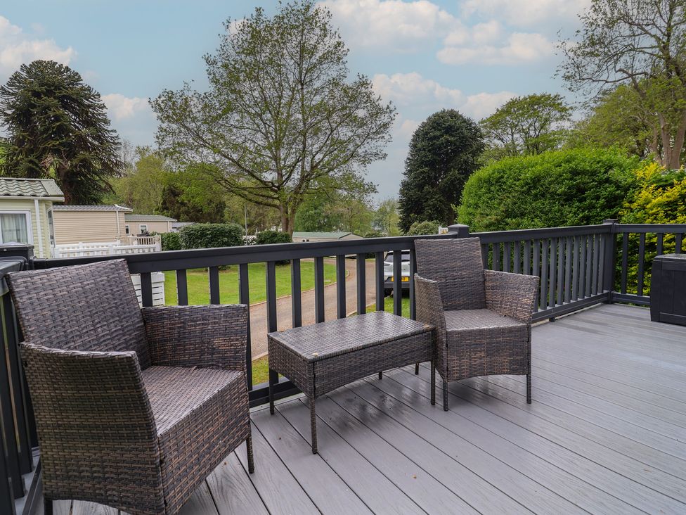 A deck with two chairs and a table at Willerby Malton in Ruthin