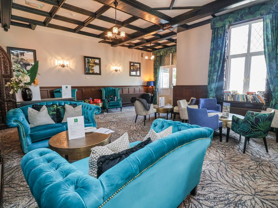 A lounge with sofas and tables at Willerby Malton in Ruthin