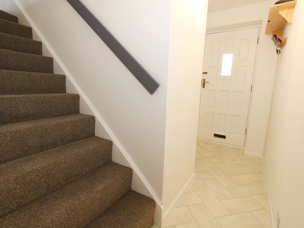 A hallway with stairs and a door at Amber House in Dorchester