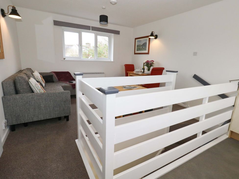 A living room with a sofa and dining area at Amber House in Dorchester