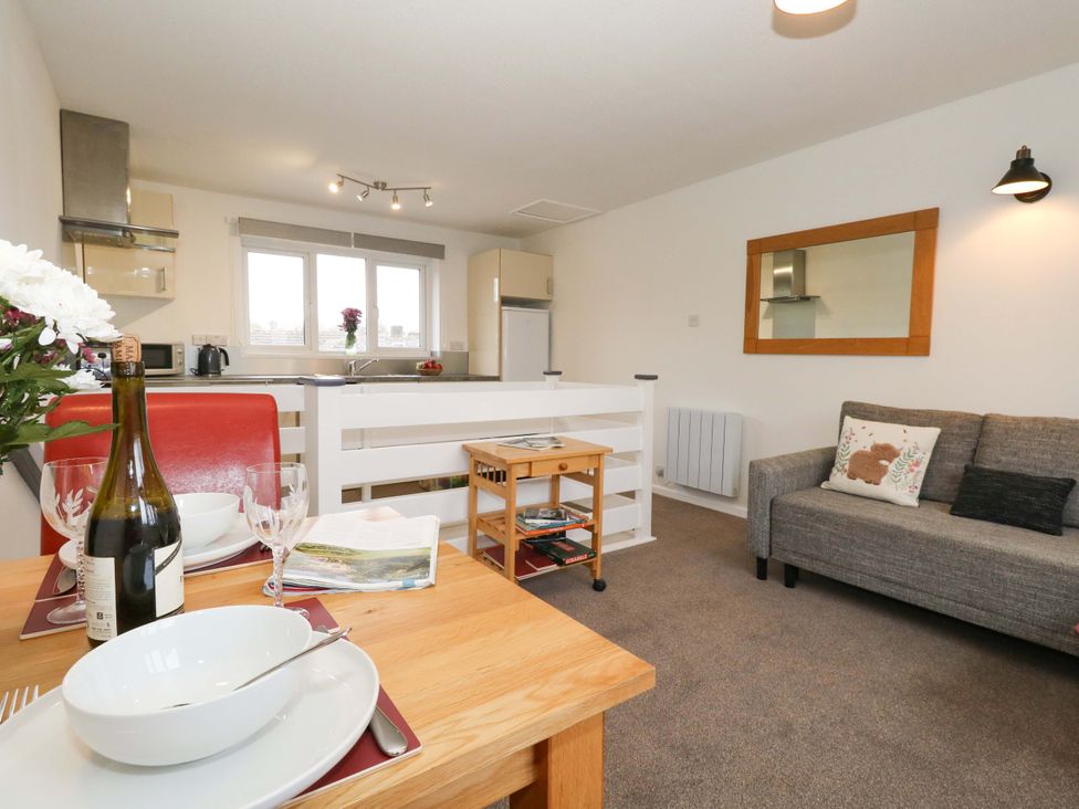A living room with a table and sofa at Amber House in Dorchester