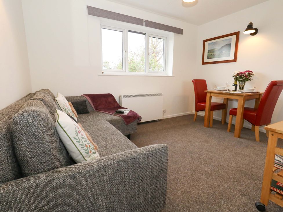 A living room with a sofa and dining table at Amber House in Dorchester