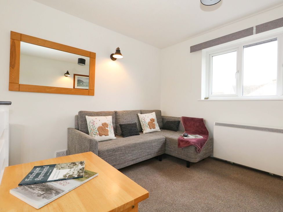 A living room with a sofa and table at Amber House in Dorchester