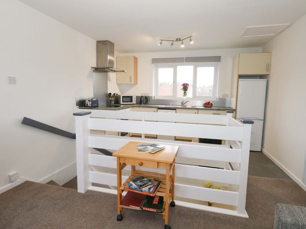 A kitchen with appliances and a table at Amber House in Dorchester