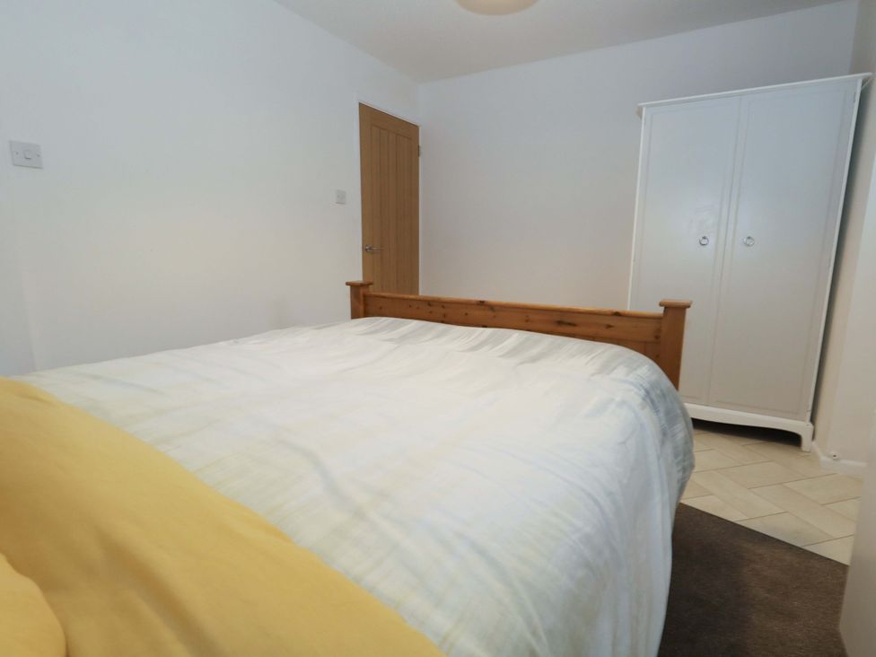 A bedroom with a bed and wardrobe at Amber House Dorchester