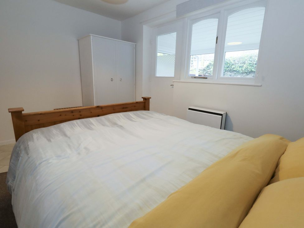 A bedroom with a bed and wardrobe at Amber House in Dorchester