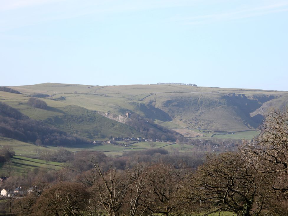 A view of hills and valleys with trees and buildings at Thorn Tree Cottage Hope Valley