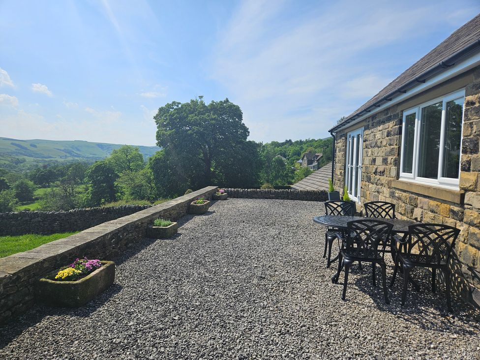 An outdoor area with a table and chairs at Thorn Tree Cottage Aston near Hope