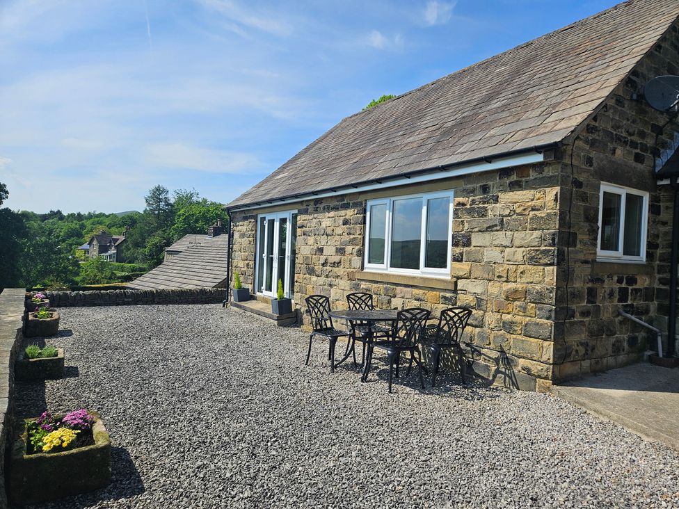 An outdoor area with a table and chairs at Thorn Tree Cottage Aston near Hope