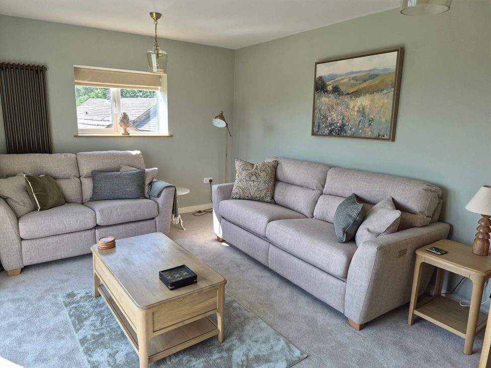 A living room with couches and a coffee table at Thorn Tree Cottage in Aston near Hope