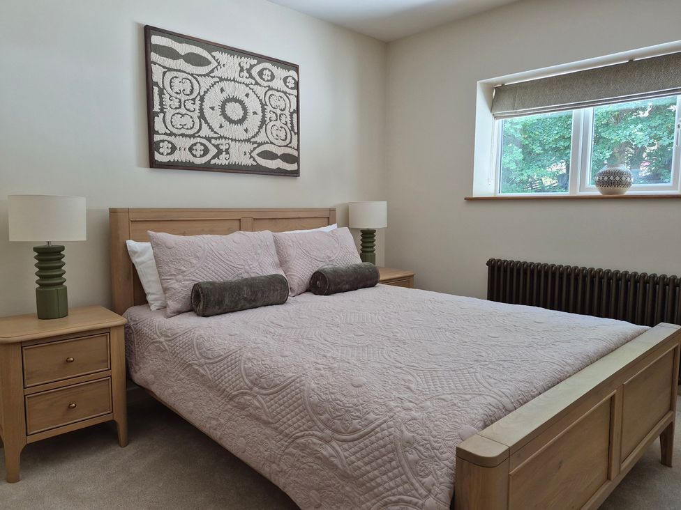 A bedroom with a bed and bedside tables at Thorn Tree Cottage in Aston near Hope