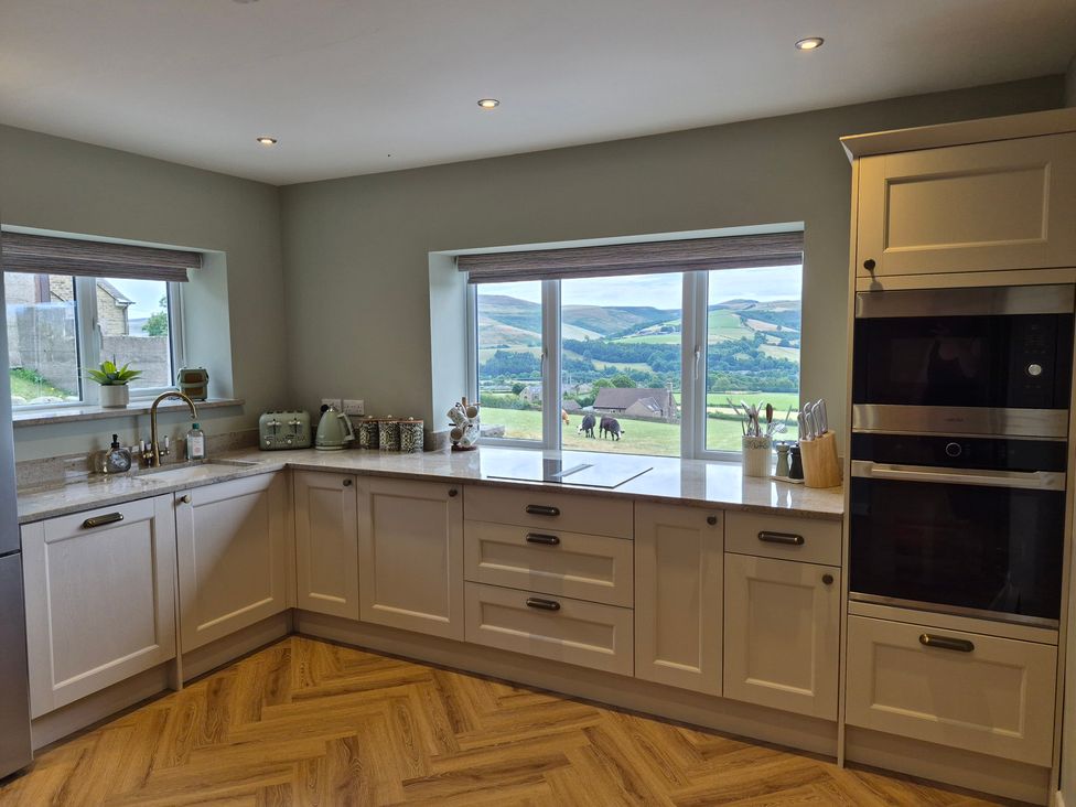 A kitchen with a window and sink at Thorn Tree Cottage in Aston near Hope