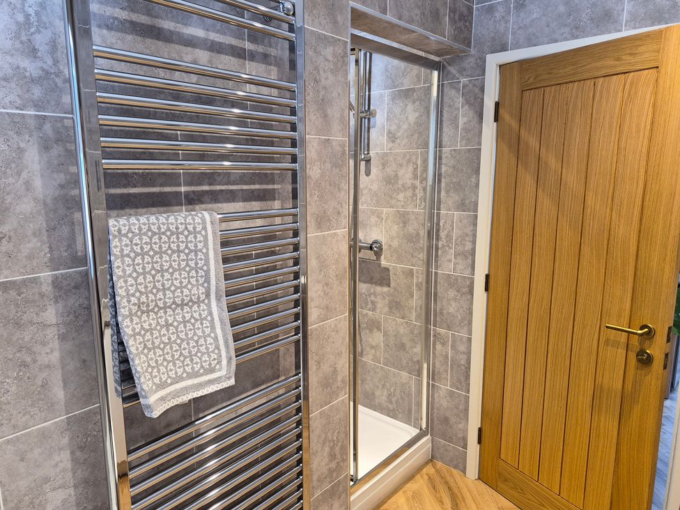 A bathroom featuring a towel rail and shower at Thorn Tree Cottage Aston near Hope