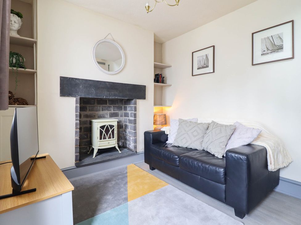 A living room with a sofa and television at Harbour Cottage in Barmouth