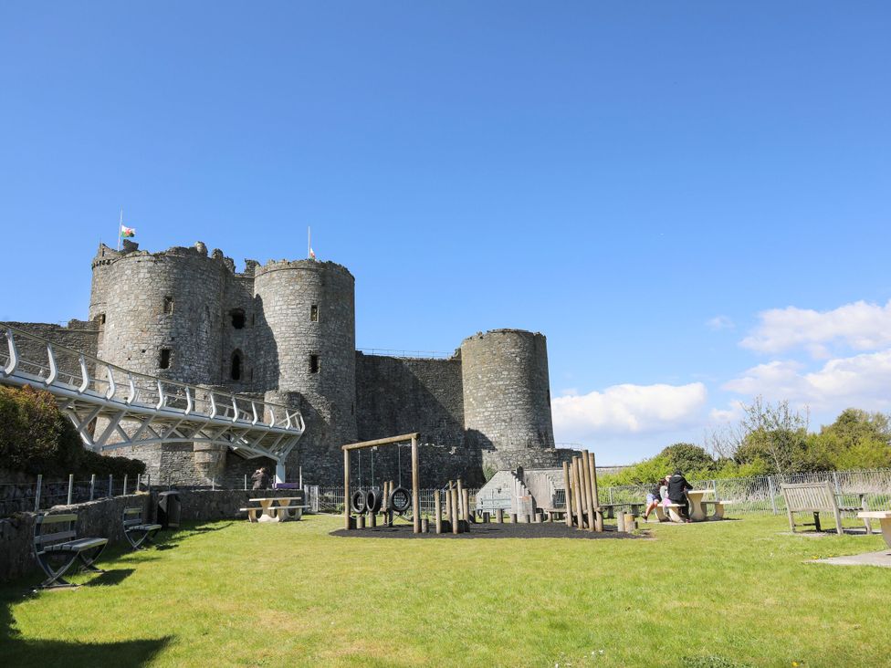An outdoor area with a castle and playground equipment at Harbour Cottage in Barmouth