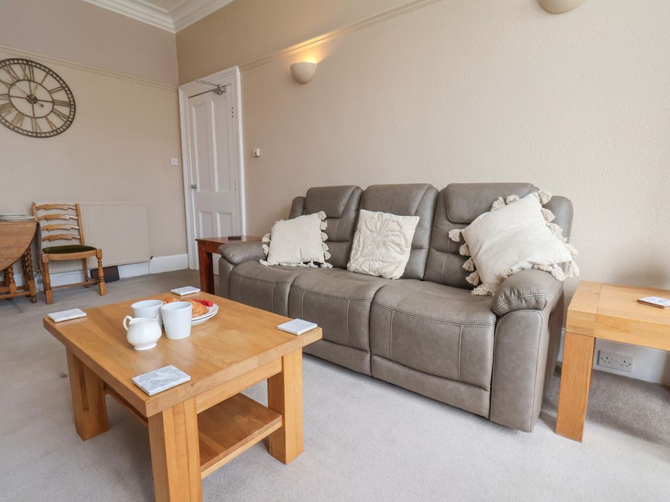 A living room with a sofa and coffee table at Time Out in Whitby