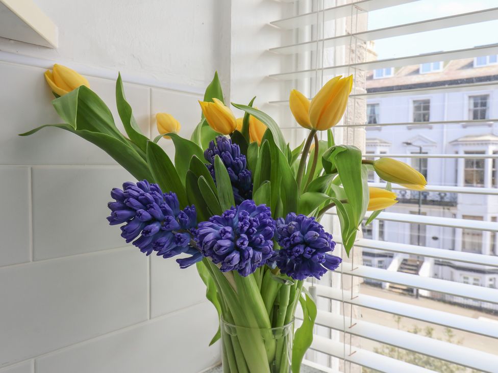 A bouquet of tulips and hyacinths in a glass vase at Time Out in Whitby