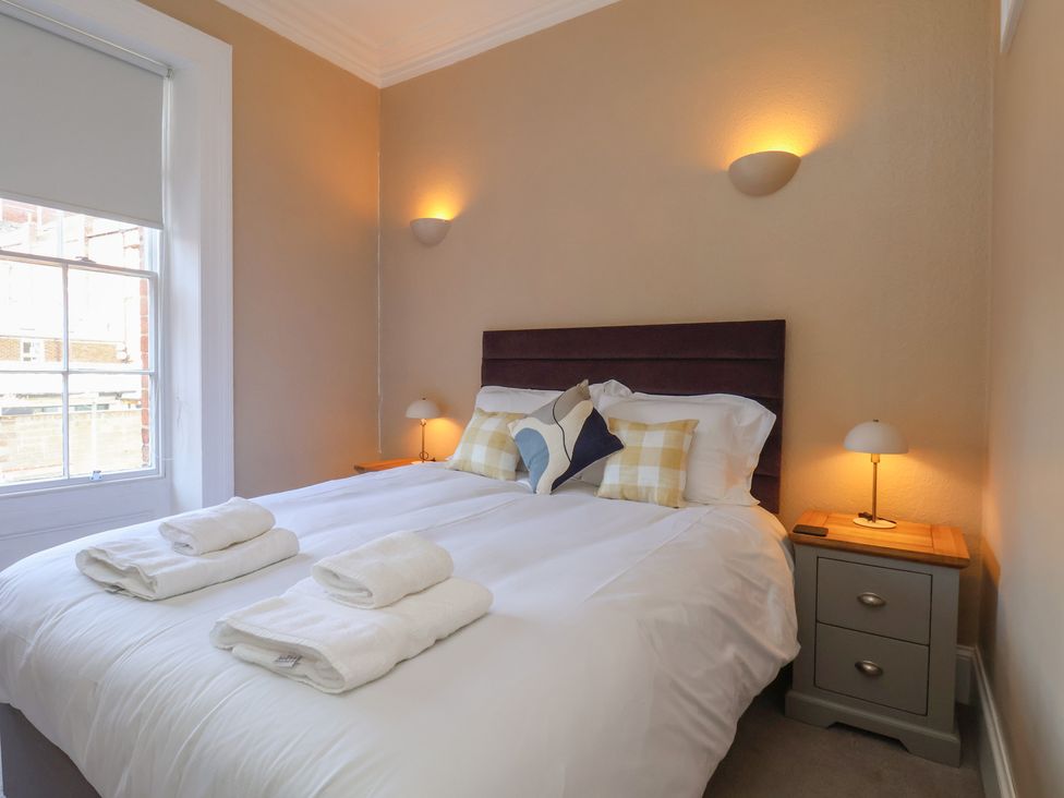 A bedroom with a bed and bedside table at Time Out in Whitby