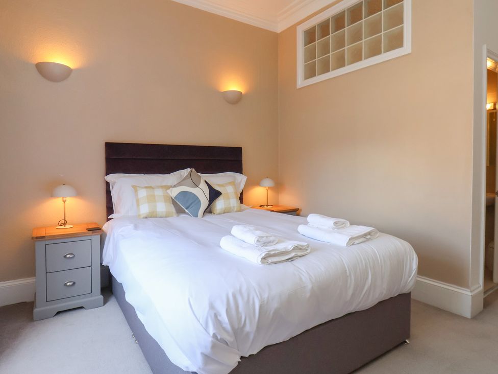 A bedroom with a double bed and bedside tables at Time Out in Whitby