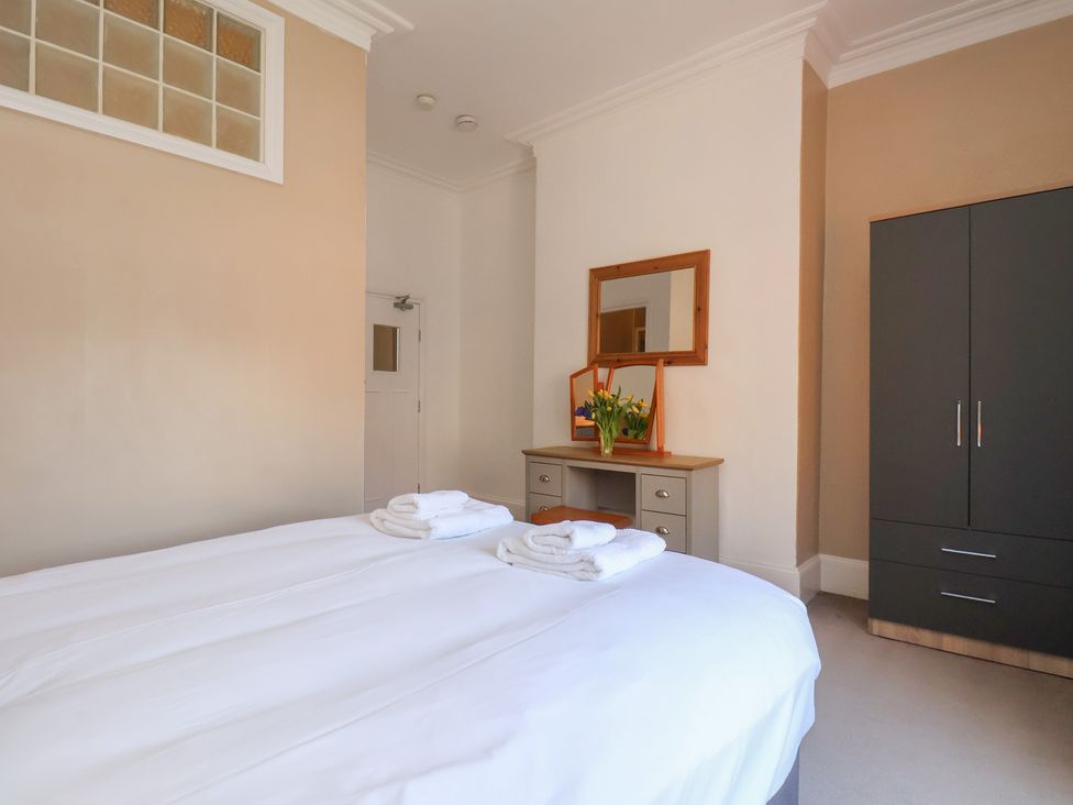 A bedroom with a bed and a mirror at Time Out in Whitby