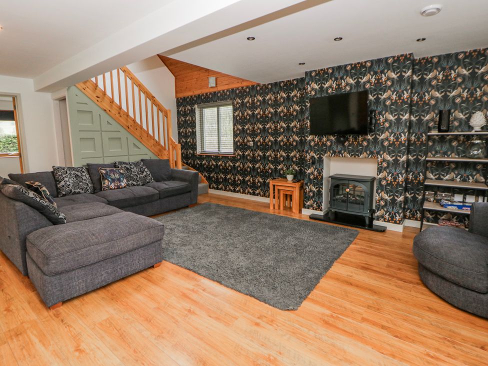 A living room with a sofa and fireplace at Maple Lodge in Knighton