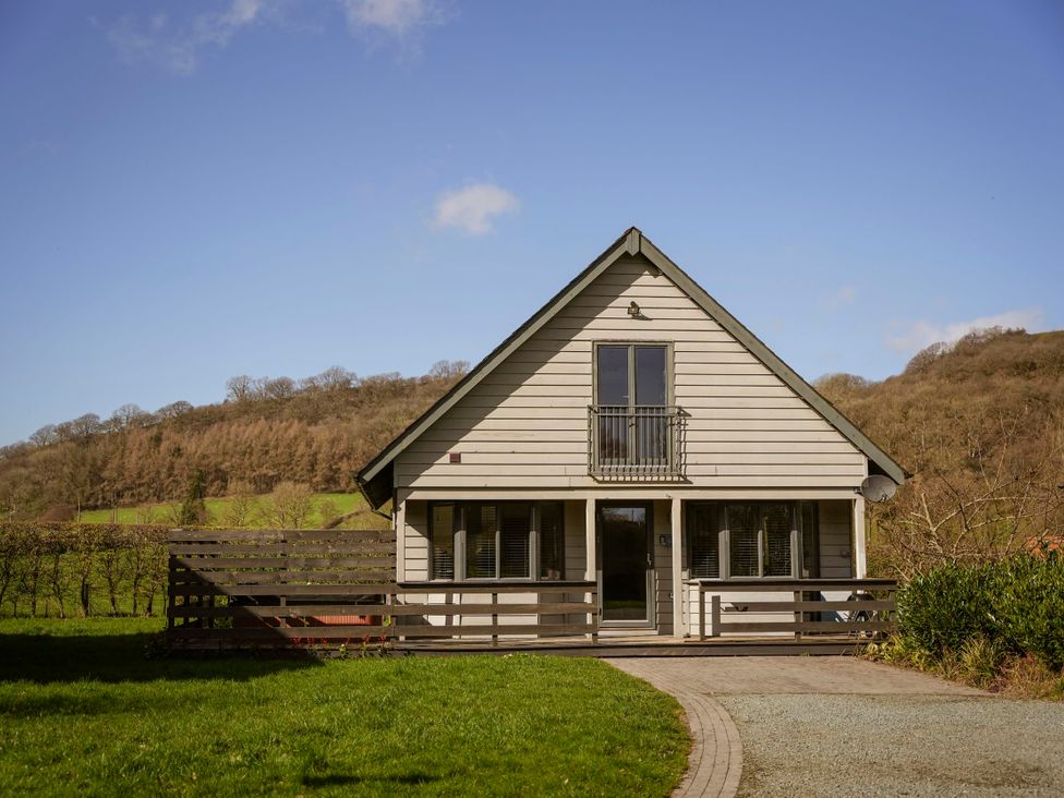 A house with a deck and balcony at Maple Lodge in Llangunllo
