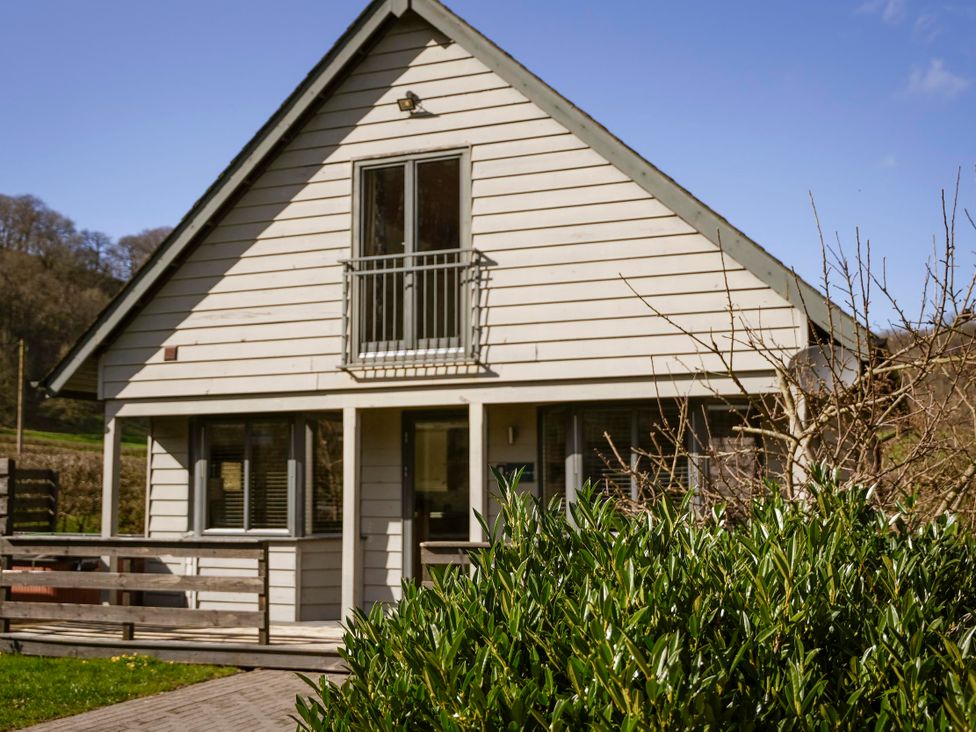 A house with a balcony and windows at Maple Lodge in Llangunllo