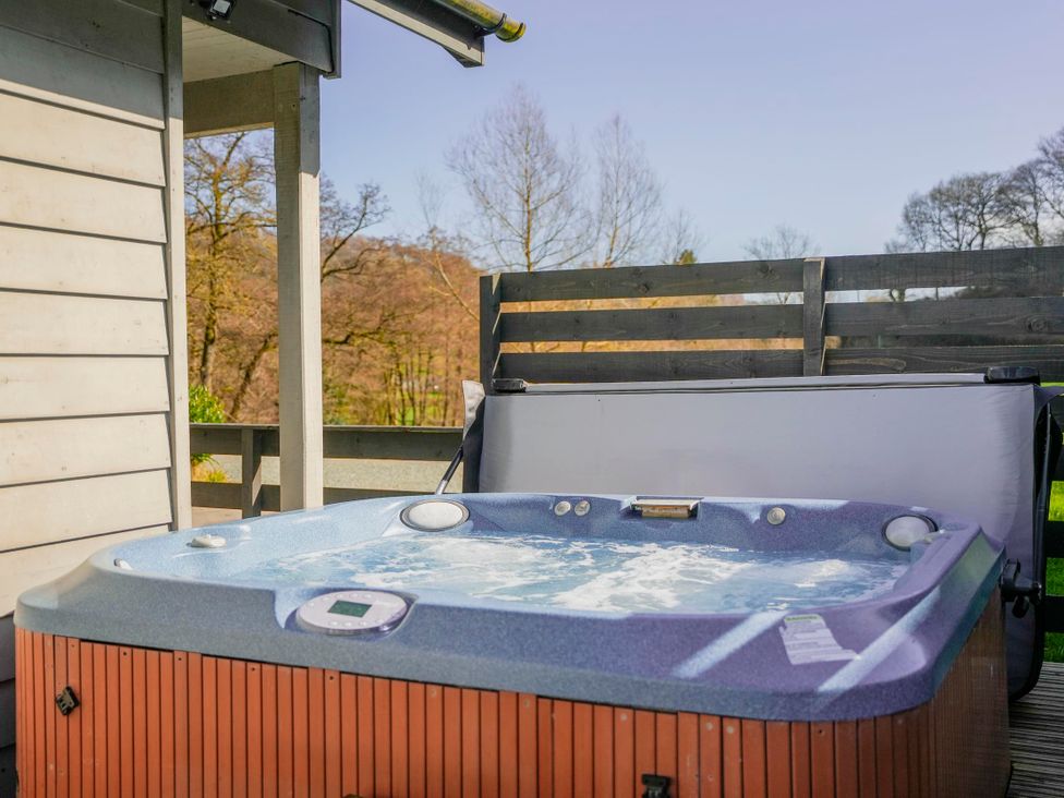 A hot tub on a deck at Maple Lodge in Llangunllo