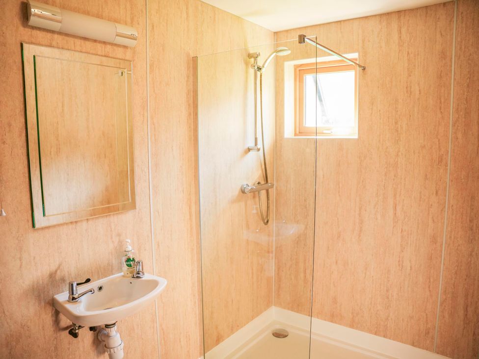 A bathroom with a shower and sink at Maple Lodge in Llangunllo