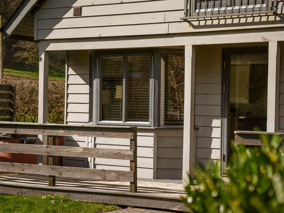 A house exterior with windows and a deck at Maple Lodge in Llangunllo