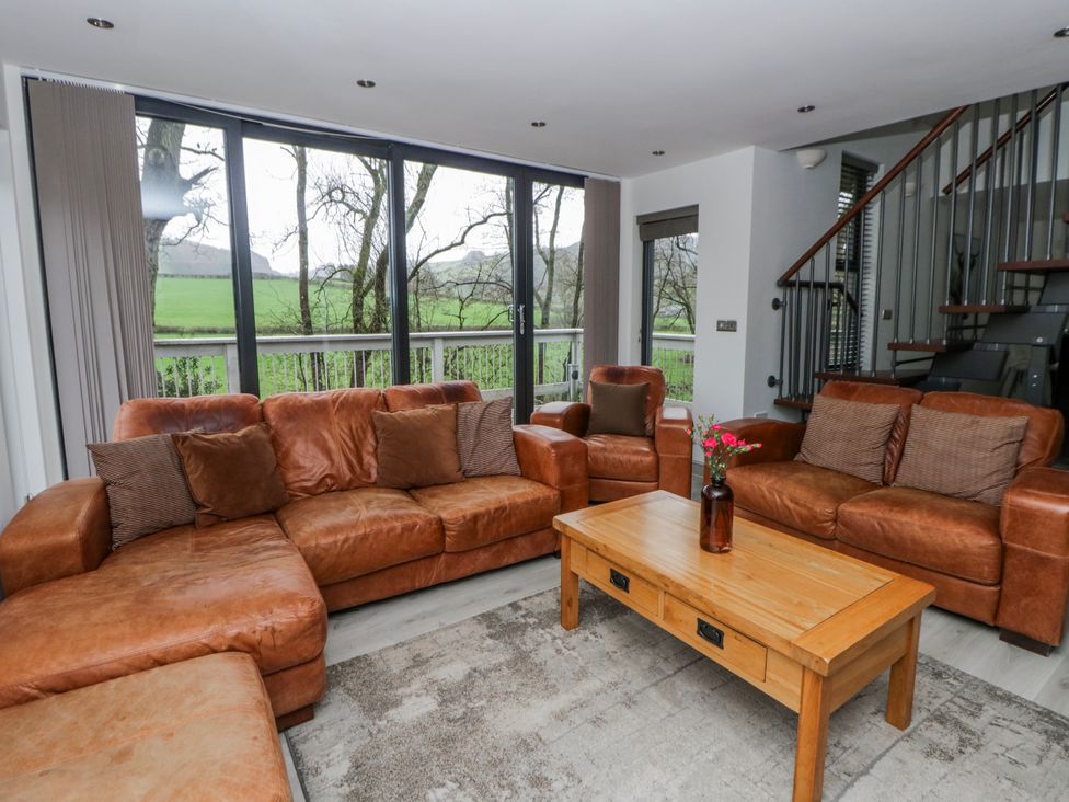 A living room with a sofa and coffee table at Oak Lodge in Knighton