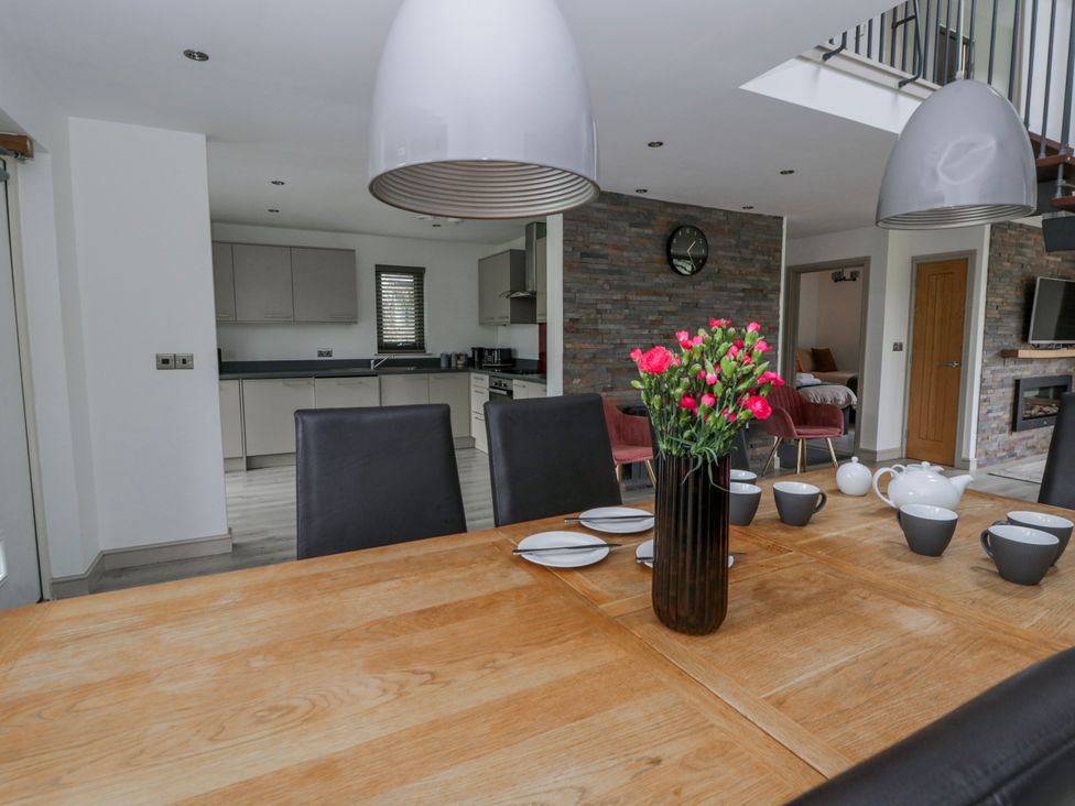 A dining room with a table and chairs at Oak Lodge Knighton