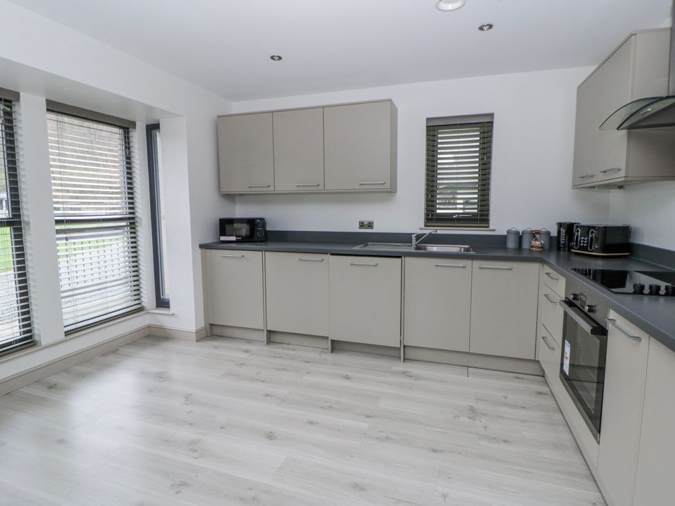 A kitchen with cabinets and appliances at Oak Lodge in Knighton